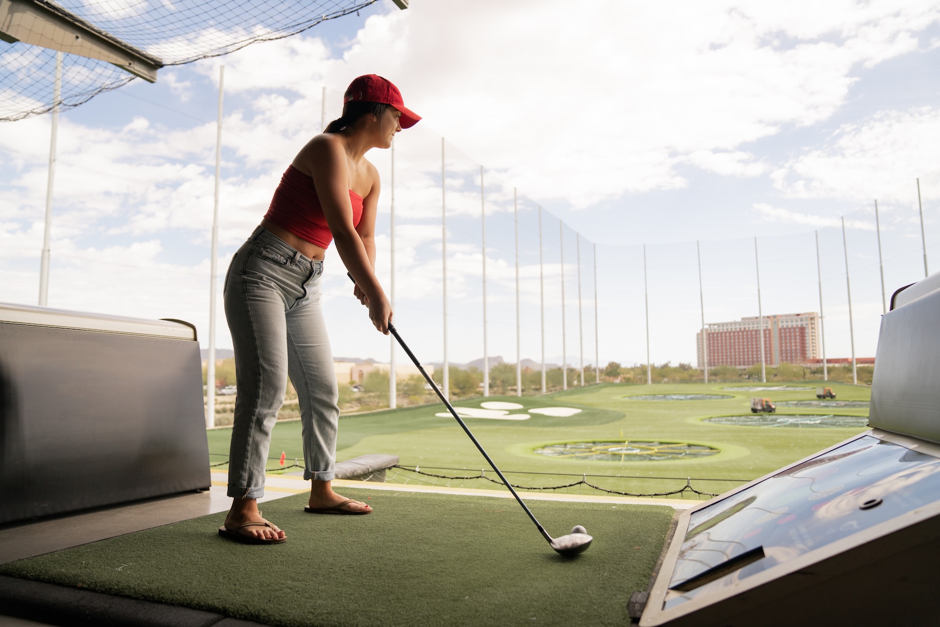 A woman plays at Topgolf, one of many fun things to do in Overland Park