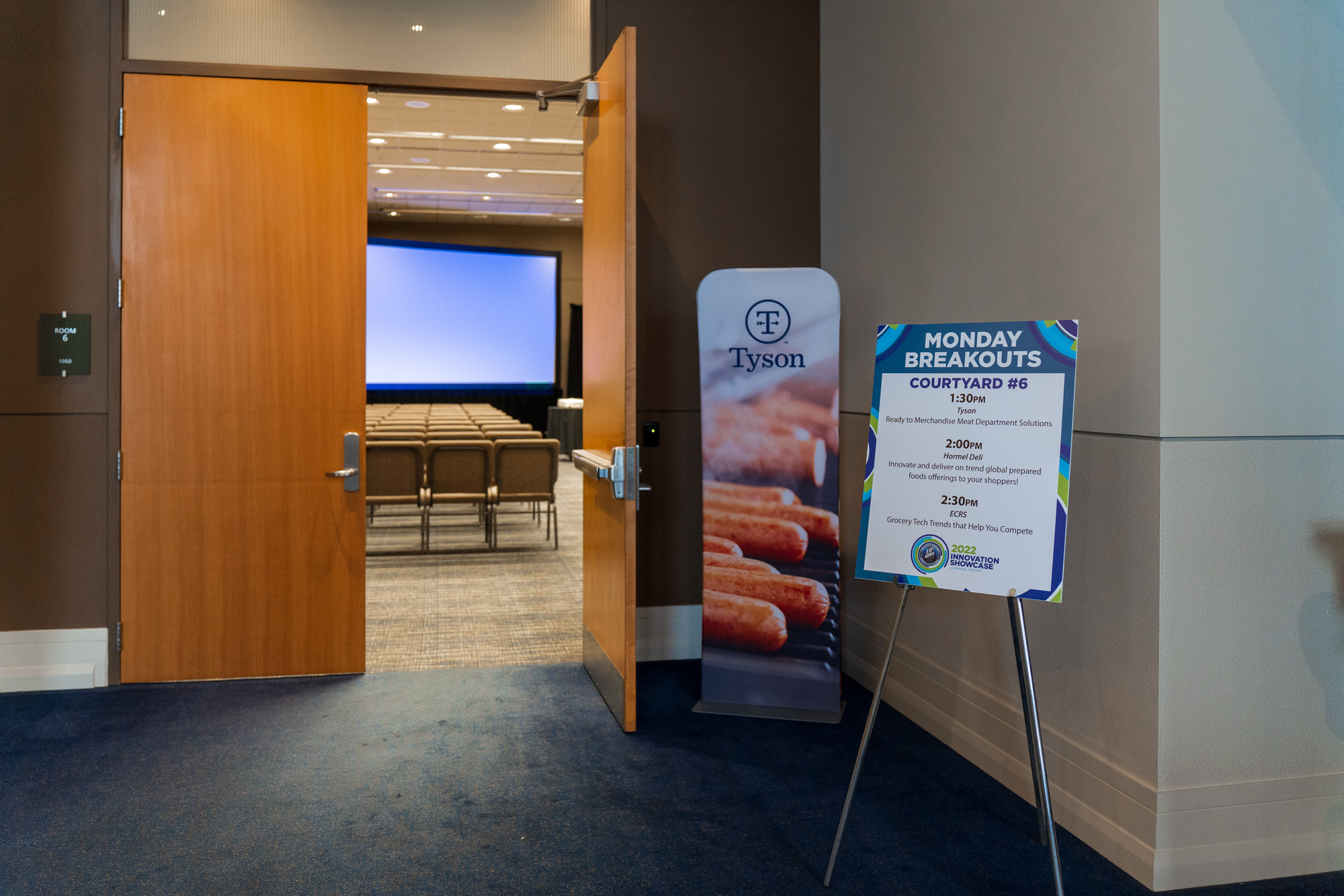A conference room with a sign highlighting breakout sessions, another of many trends in conference technology